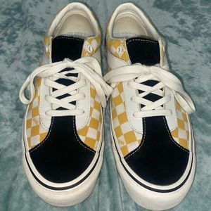 VANS checkered, low top, lace up white and yellow sneakers.